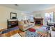 Comfortable living room showcasing a brick fireplace, hardwood floors, and stylish decor at 5576 W Rochelle Ave # 27C, Las Vegas, NV 89103