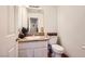 A well-lit half bathroom with granite countertops and modern fixtures at 5754 Cinnabar Ave, Las Vegas, NV 89110
