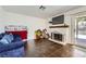 Cozy living room features a fireplace and sliding doors to the backyard at 5754 Cinnabar Ave, Las Vegas, NV 89110