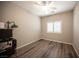 Minimalist bedroom with neutral paint and wood-look flooring, perfect for relaxation and personalization at 7252 Blowing Breeze Ave, Las Vegas, NV 89179