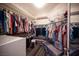 Spacious walk-in closet with built-in shelving, ample storage, and wood-look floors for organized living at 7252 Blowing Breeze Ave, Las Vegas, NV 89179