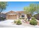 Inviting single-story home with a well-manicured front yard and attached two-car garage at 7252 Blowing Breeze Ave, Las Vegas, NV 89179