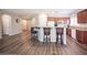 Open kitchen features stainless steel appliances and granite countertops with a bar and seating at 7252 Blowing Breeze Ave, Las Vegas, NV 89179
