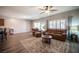 Spacious living room featuring wood floors, plush leather seating, and plenty of natural light at 7252 Blowing Breeze Ave, Las Vegas, NV 89179