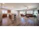 Open-concept living area with wood flooring, granite countertops, and comfortable seating at 7252 Blowing Breeze Ave, Las Vegas, NV 89179