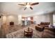 Bright and airy living area with kitchen view, wood floors, and comfortable leather furniture at 7252 Blowing Breeze Ave, Las Vegas, NV 89179