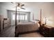 Well-lit main bedroom featuring a ceiling fan and windows with shutters at 7252 Blowing Breeze Ave, Las Vegas, NV 89179