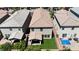 Aerial view of the home's fenced backyard featuring artificial turf, a covered patio, and a blue tarp at 7960 Calito St, Las Vegas, NV 89166