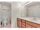 Bright bathroom with a single sink vanity, neutral walls, and tile flooring provides a clean and functional space at 7960 Calito St, Las Vegas, NV 89166