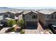 Charming two-story home with a tile roof, desert landscaping, and a two-car garage at 7960 Calito St, Las Vegas, NV 89166