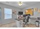 Home office with carpet flooring features a desk and natural light from the window at 7960 Calito St, Las Vegas, NV 89166