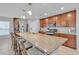 Eat-in kitchen island features granite countertops, pendant lighting, and stainless steel appliances at 7960 Calito St, Las Vegas, NV 89166