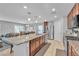 The kitchen features a large island, granite countertops, a stainless steel refrigerator, and an eat-in dining area at 7960 Calito St, Las Vegas, NV 89166