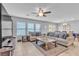 Living room boasts a comfortable couch with stylish pillows, a ceiling fan, and natural light from the windows at 7960 Calito St, Las Vegas, NV 89166