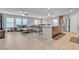 Open-concept living room features a large couch, tile flooring, and a view of the kitchen and dining area at 7960 Calito St, Las Vegas, NV 89166