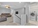 Cozy carpeted loft area featuring comfortable seating and a convenient laundry area at 7960 Calito St, Las Vegas, NV 89166