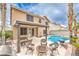 Backyard featuring a sparkling pool, covered patio, and cozy seating area with a fire pit for entertaining at 8737 Autumn Valley Ave, Las Vegas, NV 89129