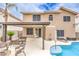Backyard with a sparkling pool, a covered patio with an outdoor dining area, and lounge chairs for relaxation at 8737 Autumn Valley Ave, Las Vegas, NV 89129