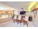 Basement wet bar featuring a wooden bar, barstools, overhead lighting, liquor shelf, and TV at 8737 Autumn Valley Ave, Las Vegas, NV 89129