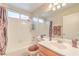 Bright bathroom with shower-tub combination, large mirror, and tile surround at 8737 Autumn Valley Ave, Las Vegas, NV 89129