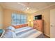 Comfortable bedroom featuring a ceiling fan, natural light, and neutral decor at 8737 Autumn Valley Ave, Las Vegas, NV 89129