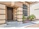 A home's front door is framed by decorative pillars and well-maintained landscaping at 8737 Autumn Valley Ave, Las Vegas, NV 89129