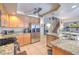 Open kitchen with stainless steel appliances, granite countertops, and access to the staircase at 8737 Autumn Valley Ave, Las Vegas, NV 89129