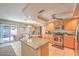 Bright kitchen with stainless steel appliances, granite countertops, sliding glass doors to outside patio at 8737 Autumn Valley Ave, Las Vegas, NV 89129