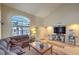 A living room with a vaulted ceiling, a large window, a comfortable sofa, and a popcorn machine at 8737 Autumn Valley Ave, Las Vegas, NV 89129