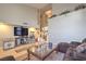A living room with a vaulted ceiling, a large window, a comfortable sofa, and a popcorn machine at 8737 Autumn Valley Ave, Las Vegas, NV 89129