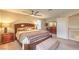 Spacious main bedroom with a ceiling fan, ensuite bathroom, and bedroom furnishings at 8737 Autumn Valley Ave, Las Vegas, NV 89129