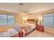 Main bedroom with a large bed, furnishings, ceiling fan, and natural light at 8737 Autumn Valley Ave, Las Vegas, NV 89129