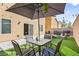 Outdoor living space with an umbrella, patio set, turf, and a built-in grill at 8937 Pelican Point St, Las Vegas, NV 89178