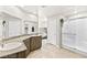 Bright bathroom with a double sink vanity, granite countertops, and a glass-enclosed shower at 8937 Pelican Point St, Las Vegas, NV 89178