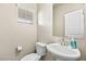 Bathroom featuring a pedestal sink, neutral wall color and a framed mirror at 8937 Pelican Point St, Las Vegas, NV 89178
