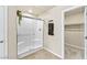 Modern bathroom with a glass-enclosed shower and a walk-in closet at 8937 Pelican Point St, Las Vegas, NV 89178
