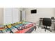 A secondary bedroom features a closet, small TV, and a desk/workspace at 8937 Pelican Point St, Las Vegas, NV 89178