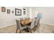 Dining room showcases a wooden table with seating for eight, along with elegant wall decor and a window at 8937 Pelican Point St, Las Vegas, NV 89178