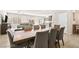 Open-concept dining area showcases a wooden table, eight chairs, and adjacent access to the living room and kitchen at 8937 Pelican Point St, Las Vegas, NV 89178