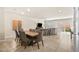 Open-concept dining area with a wooden table, six chairs, and access to the backyard through sliding glass doors at 8937 Pelican Point St, Las Vegas, NV 89178