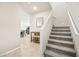 The entryway features a staircase, a hall table with seating, and tile flooring at 8937 Pelican Point St, Las Vegas, NV 89178