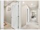 Bright hallway with carpet flooring, leading to rooms and laundry room at 8937 Pelican Point St, Las Vegas, NV 89178