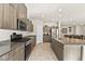 A spacious kitchen features granite countertops, stainless steel appliances and tiled flooring at 8937 Pelican Point St, Las Vegas, NV 89178