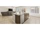 Bright open kitchen with granite island and breakfast bar and stainless steel appliances at 8937 Pelican Point St, Las Vegas, NV 89178