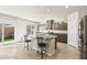 Beautiful kitchen with island, stainless appliances, granite countertops, and sliding glass door to patio at 8937 Pelican Point St, Las Vegas, NV 89178