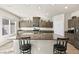 Bright kitchen boasts granite countertops, stainless appliances, island, and breakfast bar at 8937 Pelican Point St, Las Vegas, NV 89178