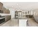 Open kitchen features granite counters, stainless appliances, and large island with breakfast bar at 8937 Pelican Point St, Las Vegas, NV 89178