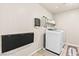 Laundry room with folding table and modern washer and dryer at 8937 Pelican Point St, Las Vegas, NV 89178
