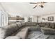 Spacious open-concept living area with a large sectional sofa and seamless access to the kitchen and dining areas at 8937 Pelican Point St, Las Vegas, NV 89178