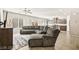 Comfortable living room featuring a large sectional sofa, TV, and open access to the kitchen at 8937 Pelican Point St, Las Vegas, NV 89178